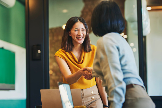 Two woman shaking hands